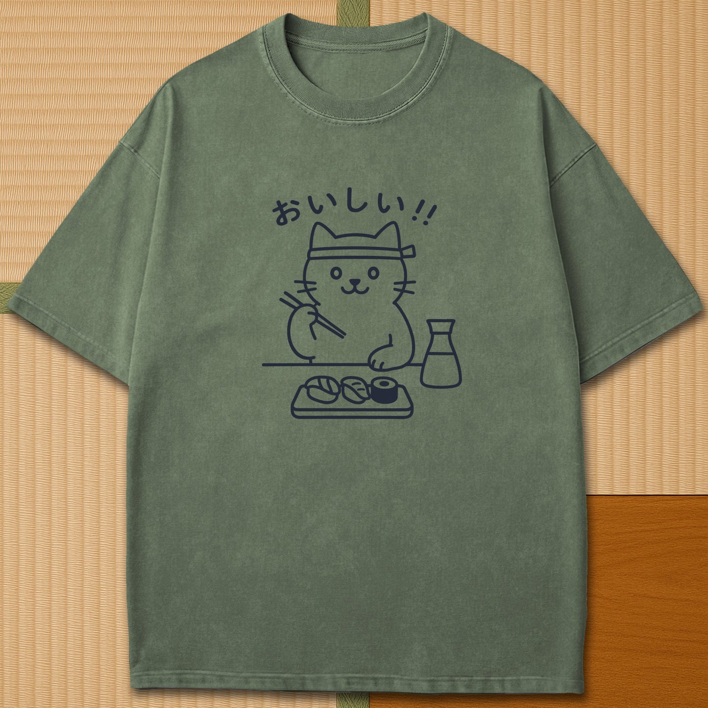 Japanese-inspired cotton Minimalist Cat & Sushi T-Shirt in Moss on Comfort Colors 1717, styled in a modern flatlay scene.