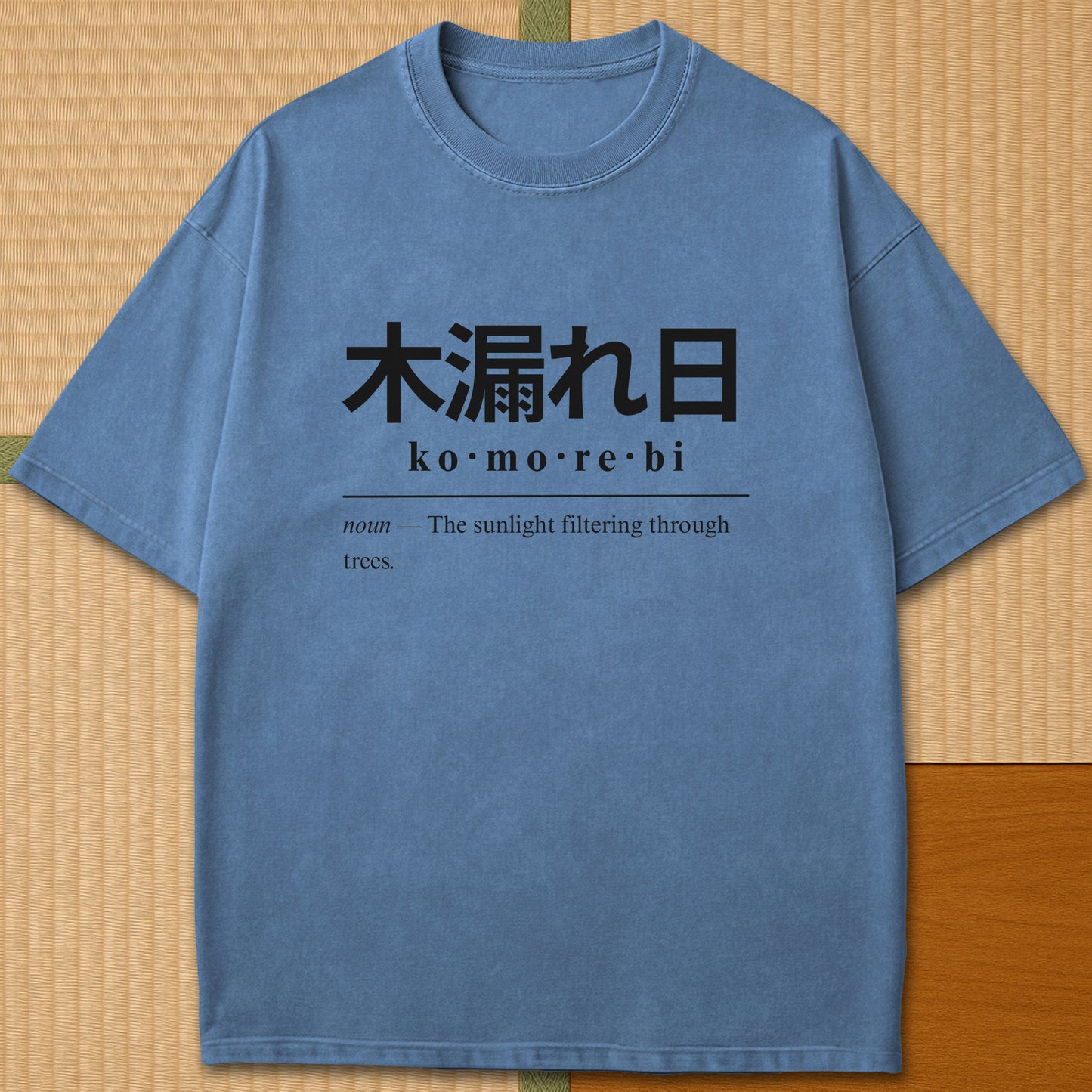 Japanese-inspired cotton Komorebi Japanese Dictionary T-Shirt in Blue Jean on Comfort Colors 1717, styled in a modern flatlay scene.