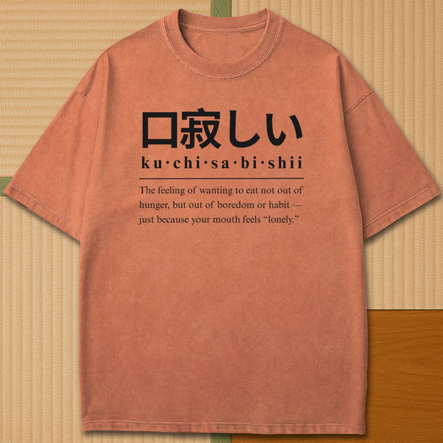 Japanese-inspired cotton Japanese Kuchisabishii Definition T-Shirt in Yam on Comfort Colors 1717, styled in a modern flatlay scene.