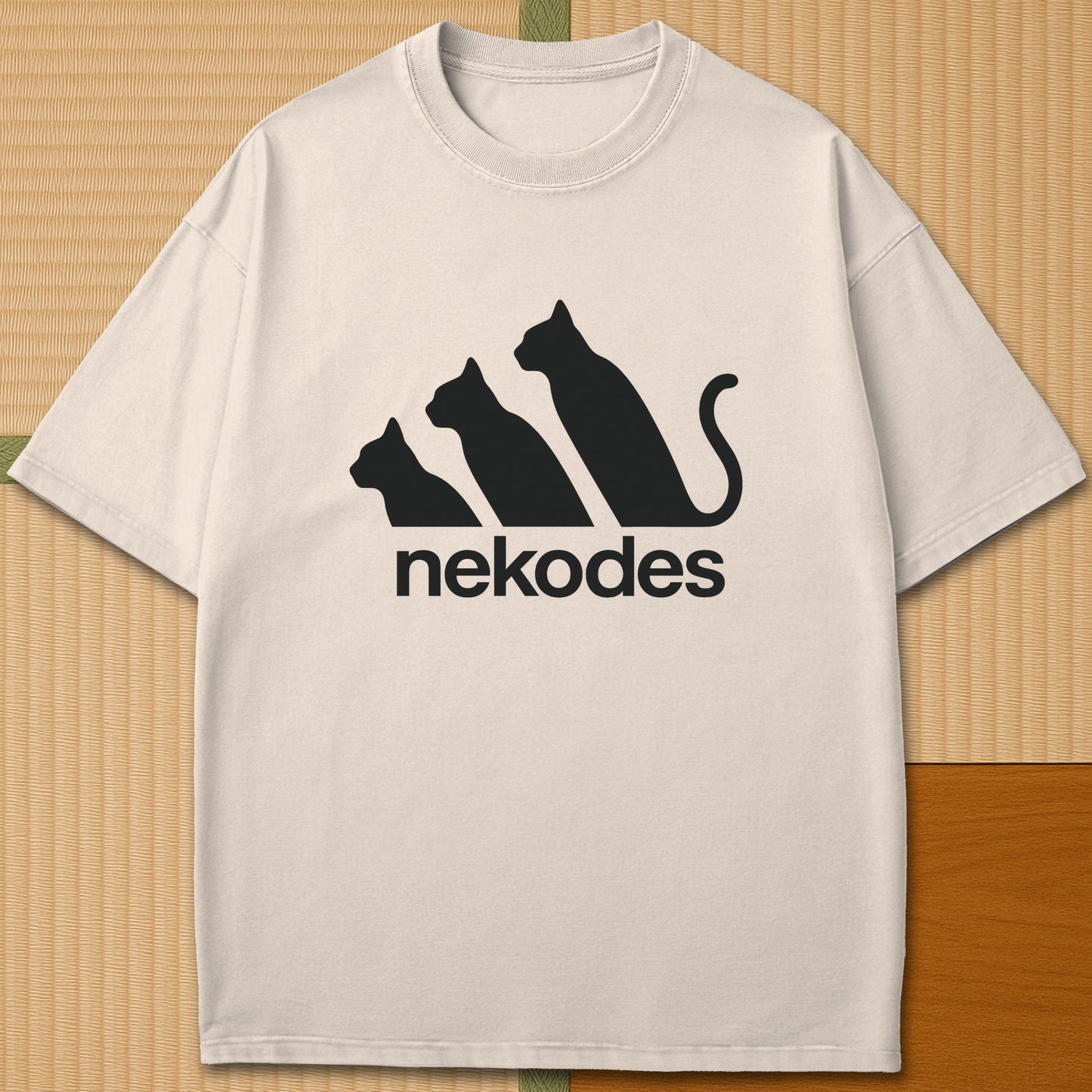 Japanese-inspired cotton Nekodes T-Shirt in Ivory on Comfort Colors 1717, styled in a modern flatlay scene.