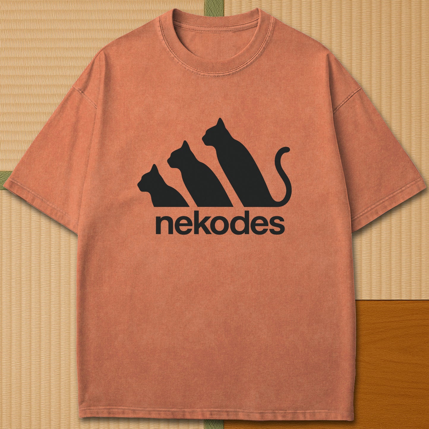 Japanese-inspired cotton Nekodes T-Shirt in Yam on Comfort Colors 1717, styled in a modern flatlay scene.