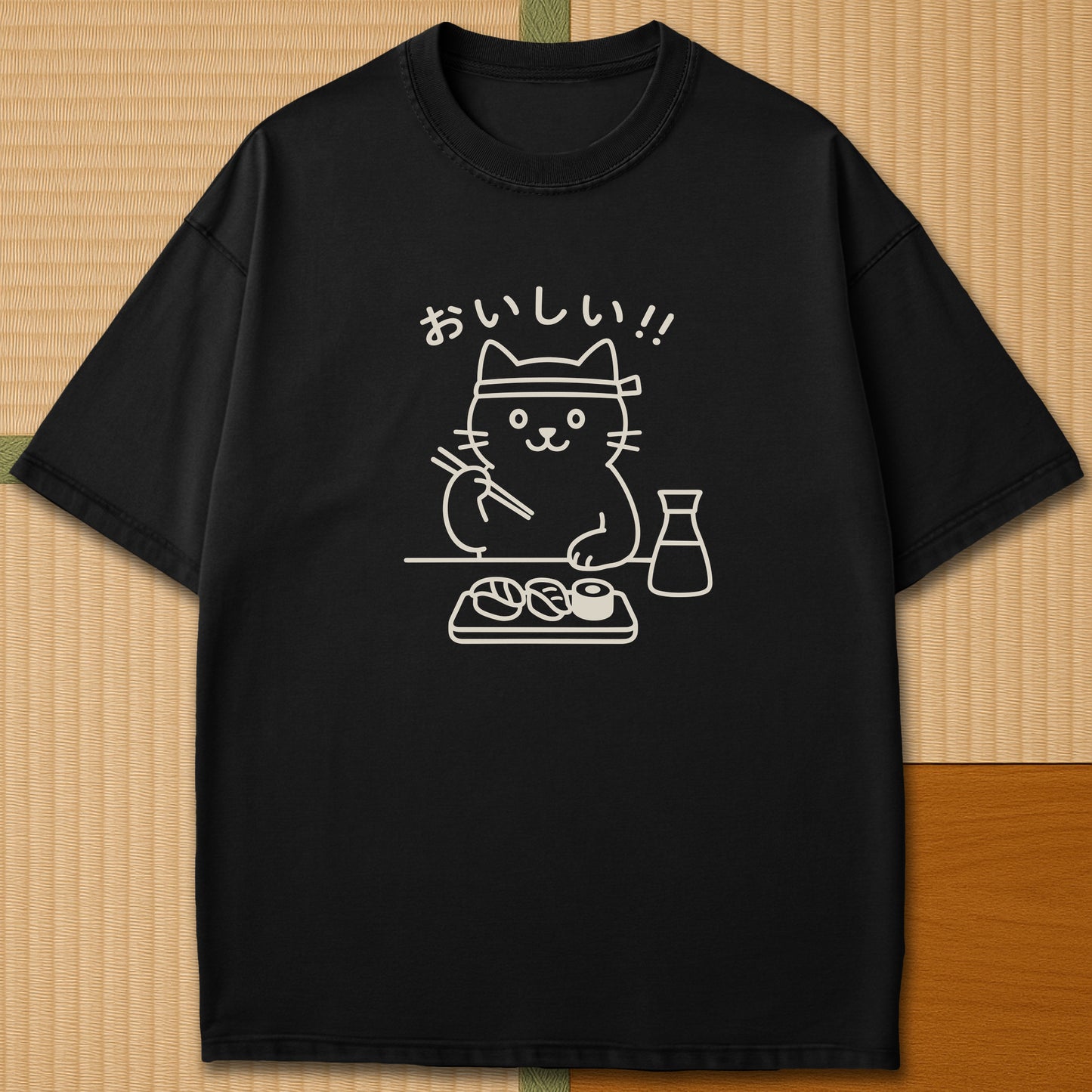 Japanese-inspired cotton Minimalist Cat & Sushi T-Shirt in Black on Comfort Colors 1717, styled in a modern flatlay scene.