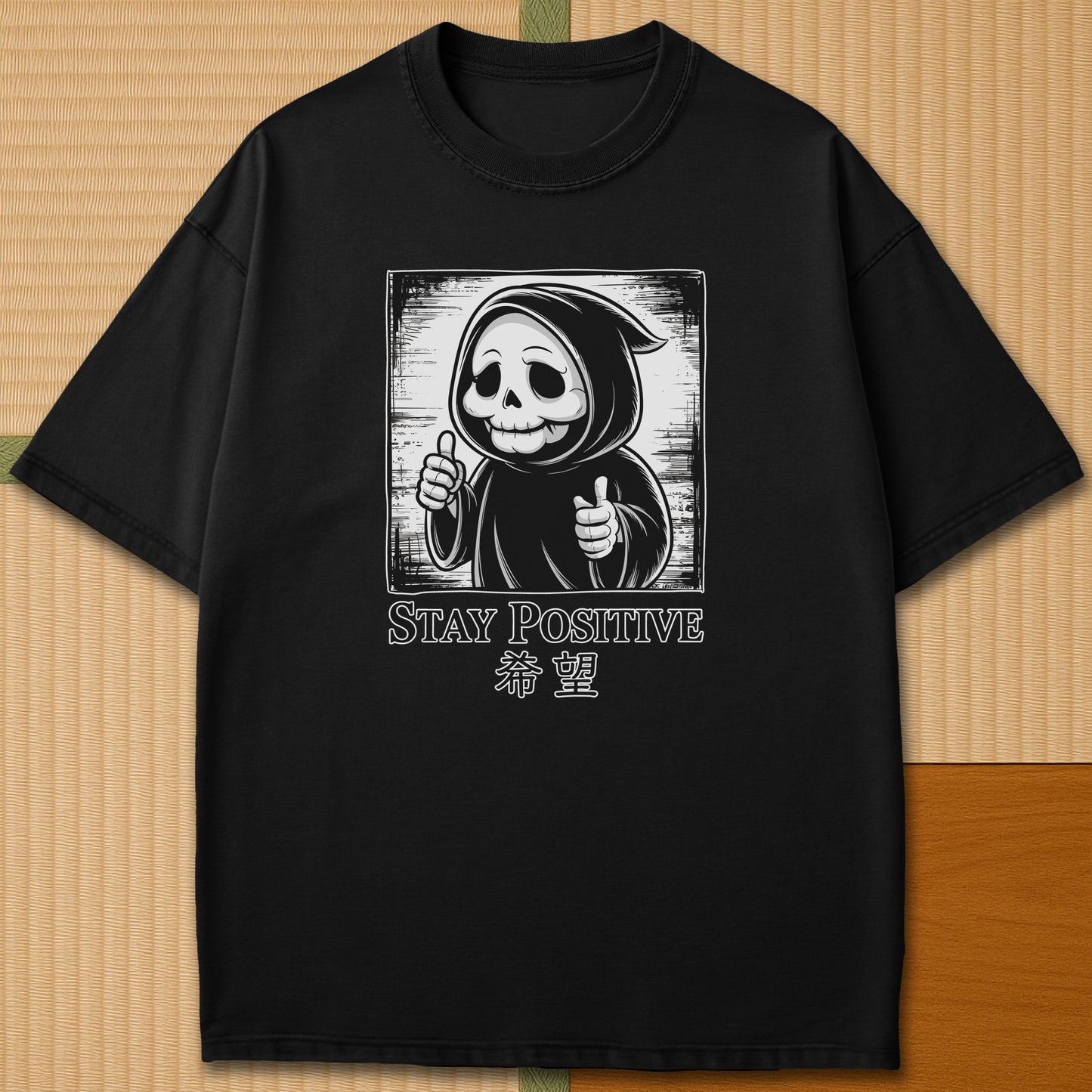 Japanese-inspired cotton Stay Positive Kawaii Grim Reaper T-Shirt in Black on Comfort Colors 1717, styled in a modern flatlay scene.