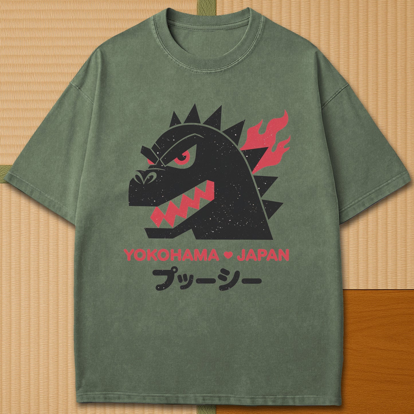 Japanese-inspired cotton Vintage Kaiju Godzilla T-Shirt in Moss on Comfort Colors 1717, styled in a modern flatlay scene.