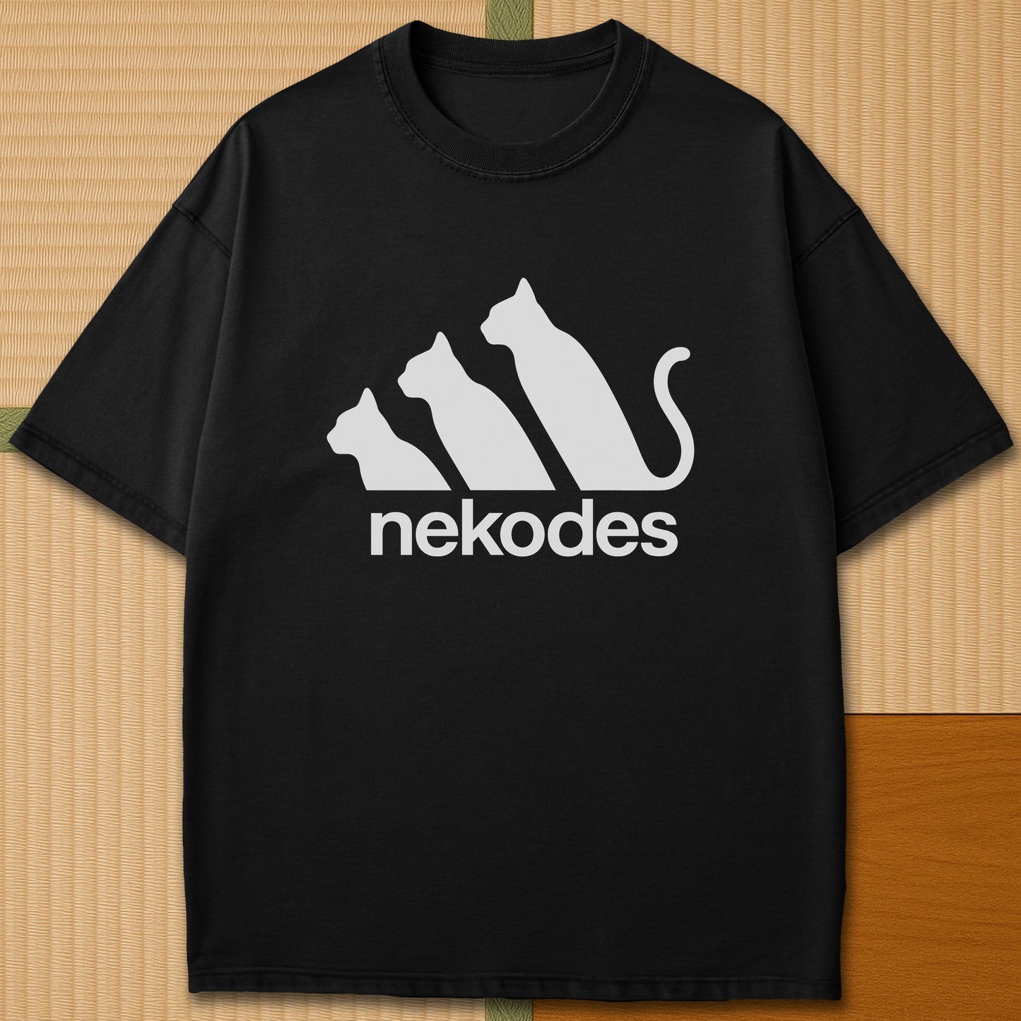 Japanese-inspired cotton Nekodes T-Shirt in Black on Comfort Colors 1717, styled in a modern flatlay scene.