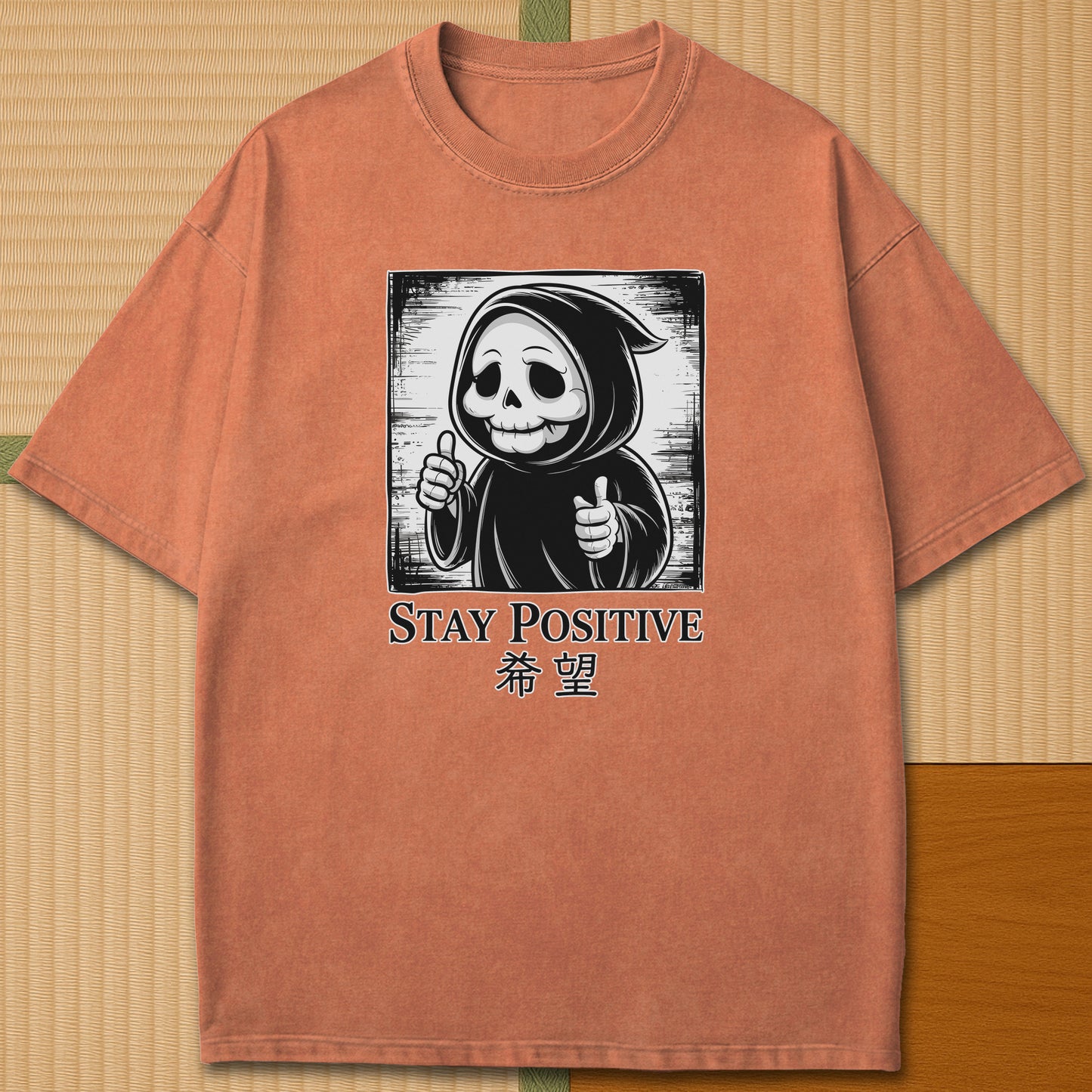 Japanese-inspired cotton Stay Positive Kawaii Grim Reaper T-Shirt in Yam on Comfort Colors 1717, styled in a modern flatlay scene.