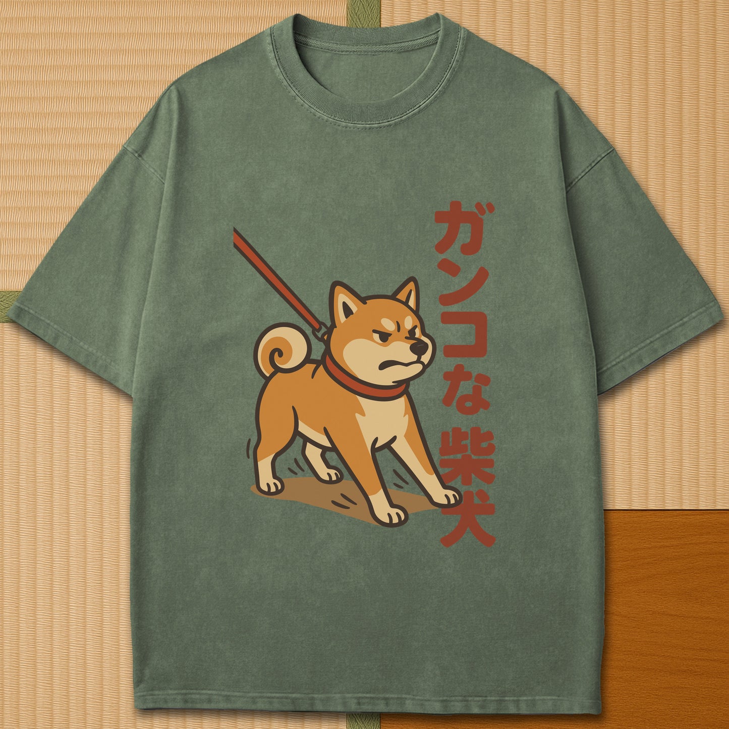 Japanese-inspired cotton Stubborn Shiba T-Shirt in Moss on Comfort Colors 1717, styled in a modern flatlay scene.