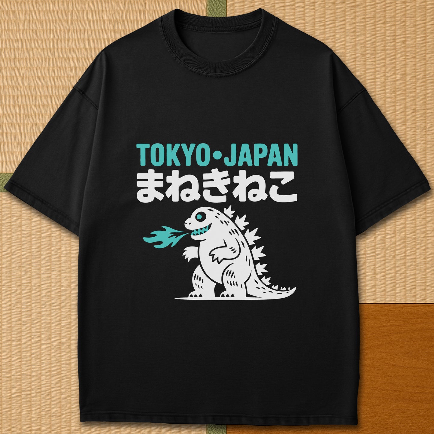 Japanese-inspired cotton Maneki Neko Monster T-Shirt in Black on Comfort Colors 1717, styled in a modern flatlay scene.