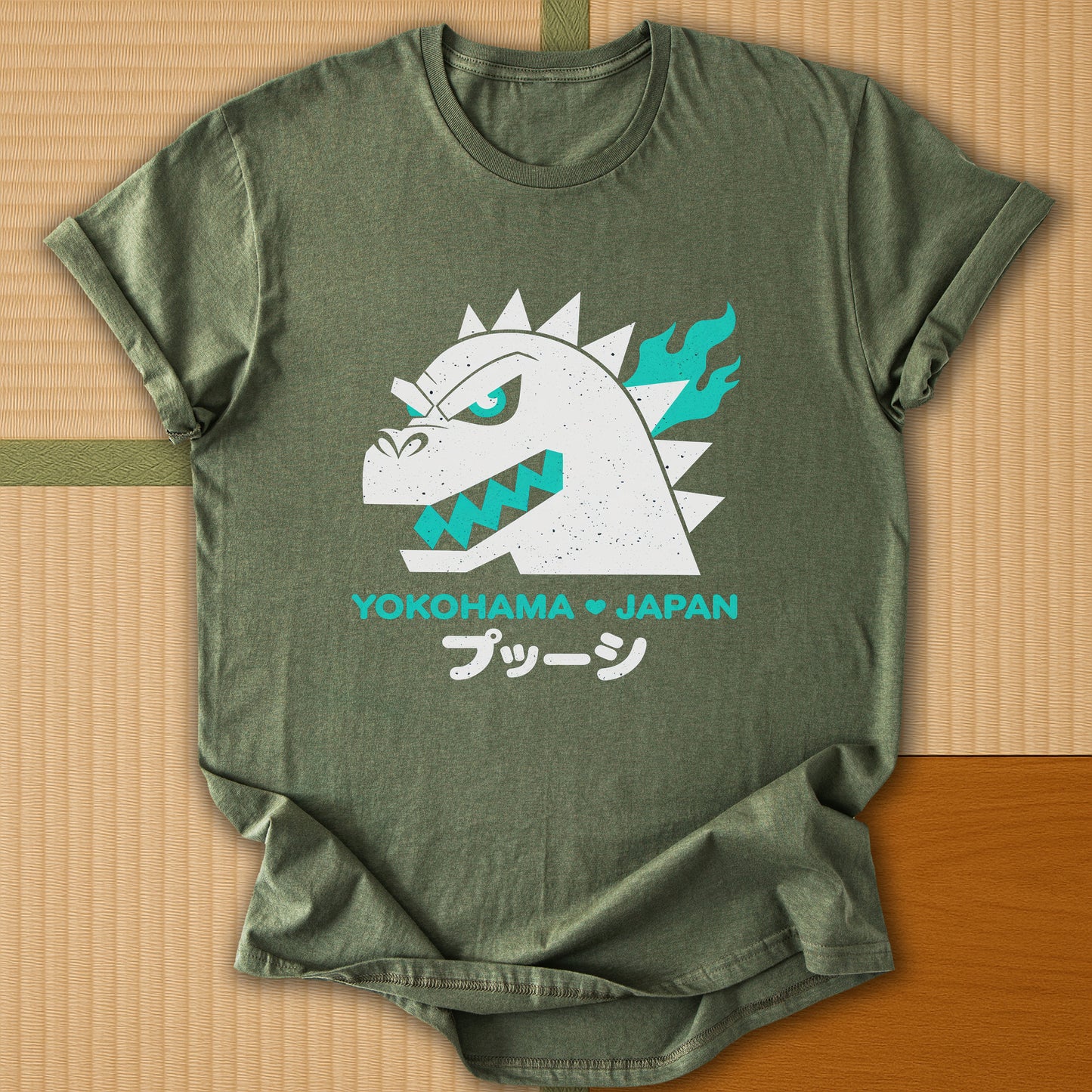 Japanese-inspired cotton Vintage Kaiju Godzilla T-Shirt in Military Green on Gildan 64000, styled in a modern flatlay scene