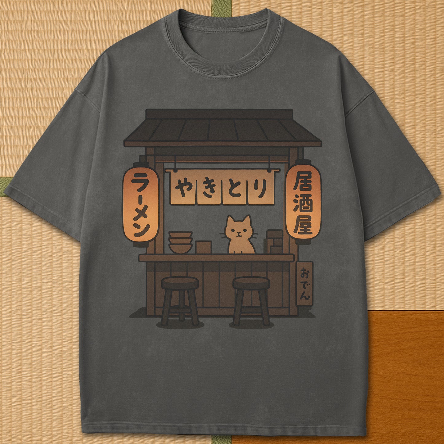 Japanese-inspired cotton Cozy Cat At Japanese Yatai T-Shirt in Pepper on Comfort Colors 1717, styled in a modern flatlay scene.