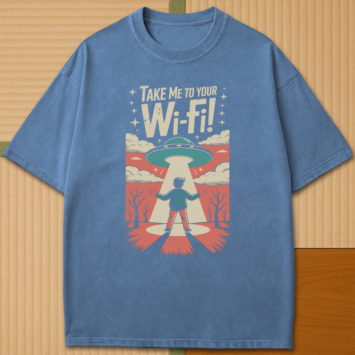 Japanese-inspired cotton Gaijin Abduction T-Shirt in Blue Jean on Comfort Colors 1717, styled in a modern flatlay scene.