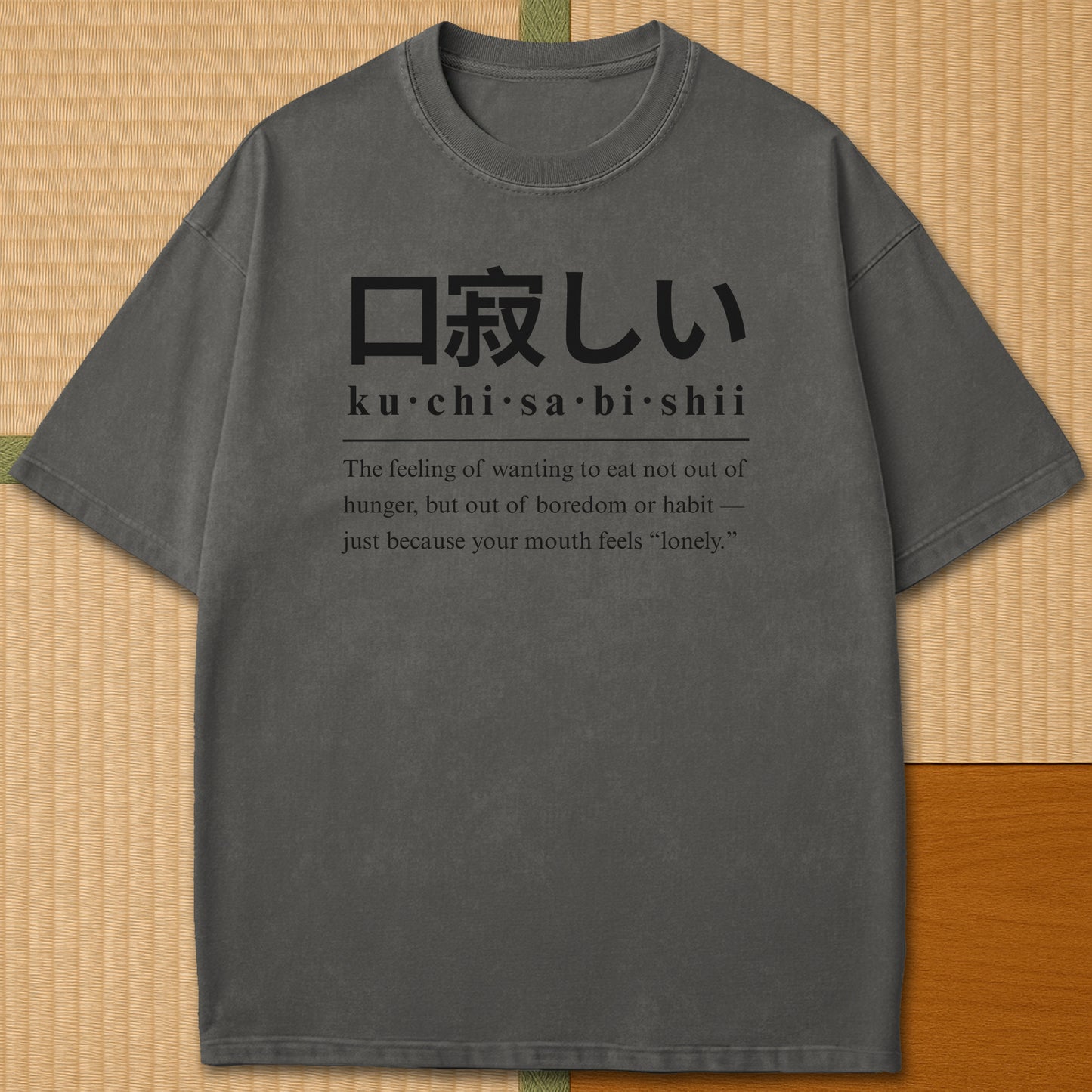 Japanese-inspired cotton Japanese Kuchisabishii Definition T-Shirt in Pepper on Comfort Colors 1717, styled in a modern flatlay scene.