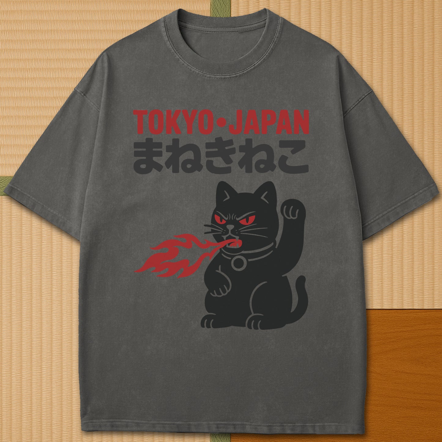 Japanese-inspired cotton Maneki Neko Monster T-Shirt in Pepper on Comfort Colors 1717, styled in a modern flatlay scene.