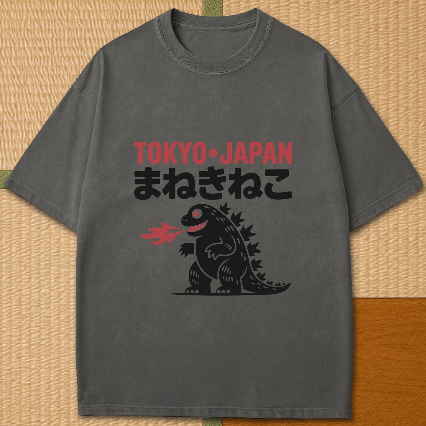 Japanese-inspired cotton Maneki Neko Monster T-Shirt in Pepper on Comfort Colors 1717, styled in a modern flatlay scene.