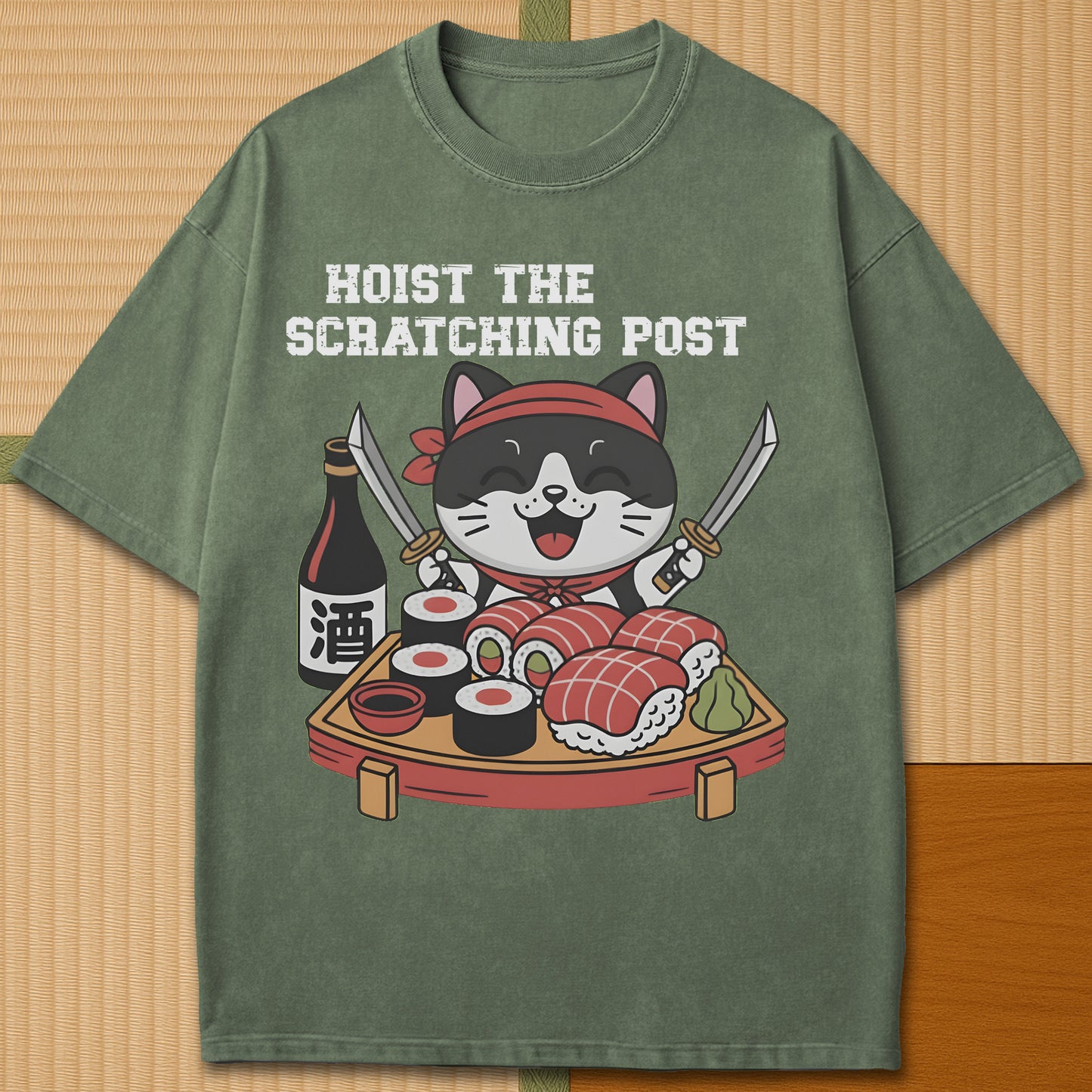 Japanese-inspired cotton Sushi Pirate Hoist The Scratching Post T-Shirt in Moss on Comfort Colors 1717, styled in a modern flatlay scene.