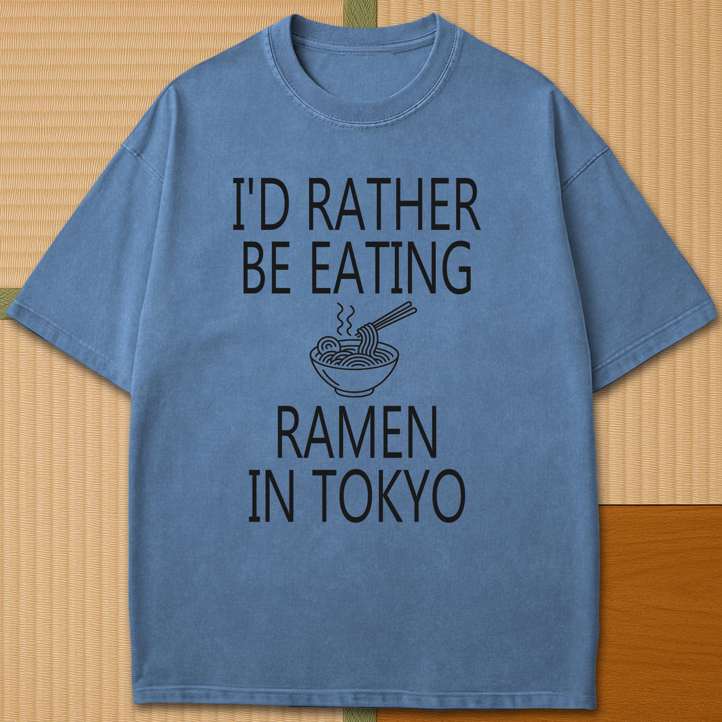 Japanese-inspired cotton Rather Be Eating Ramen T-Shirt in Blue Jean on Comfort Colors 1717, styled in a modern flatlay scene.
