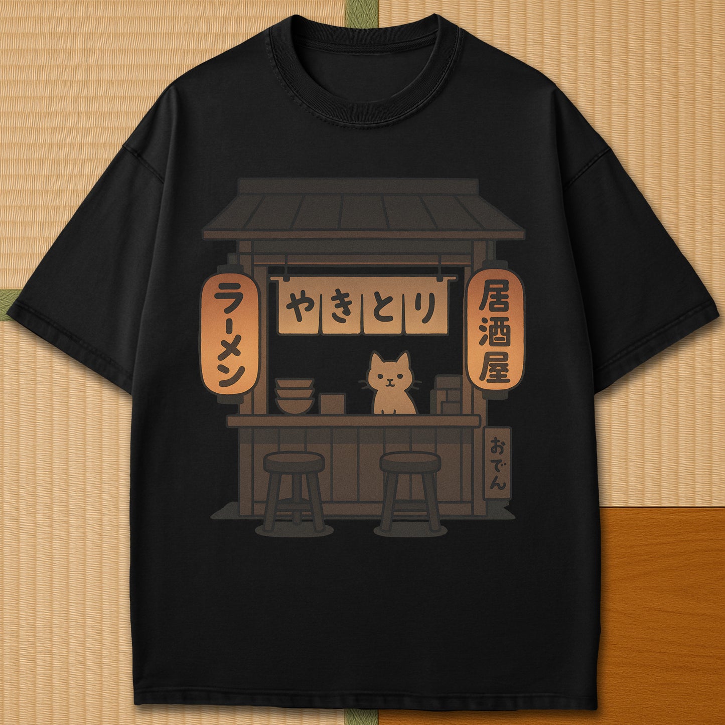Japanese-inspired cotton Cozy Cat At Japanese Yatai T-Shirt in Black on Comfort Colors 1717, styled in a modern flatlay scene.