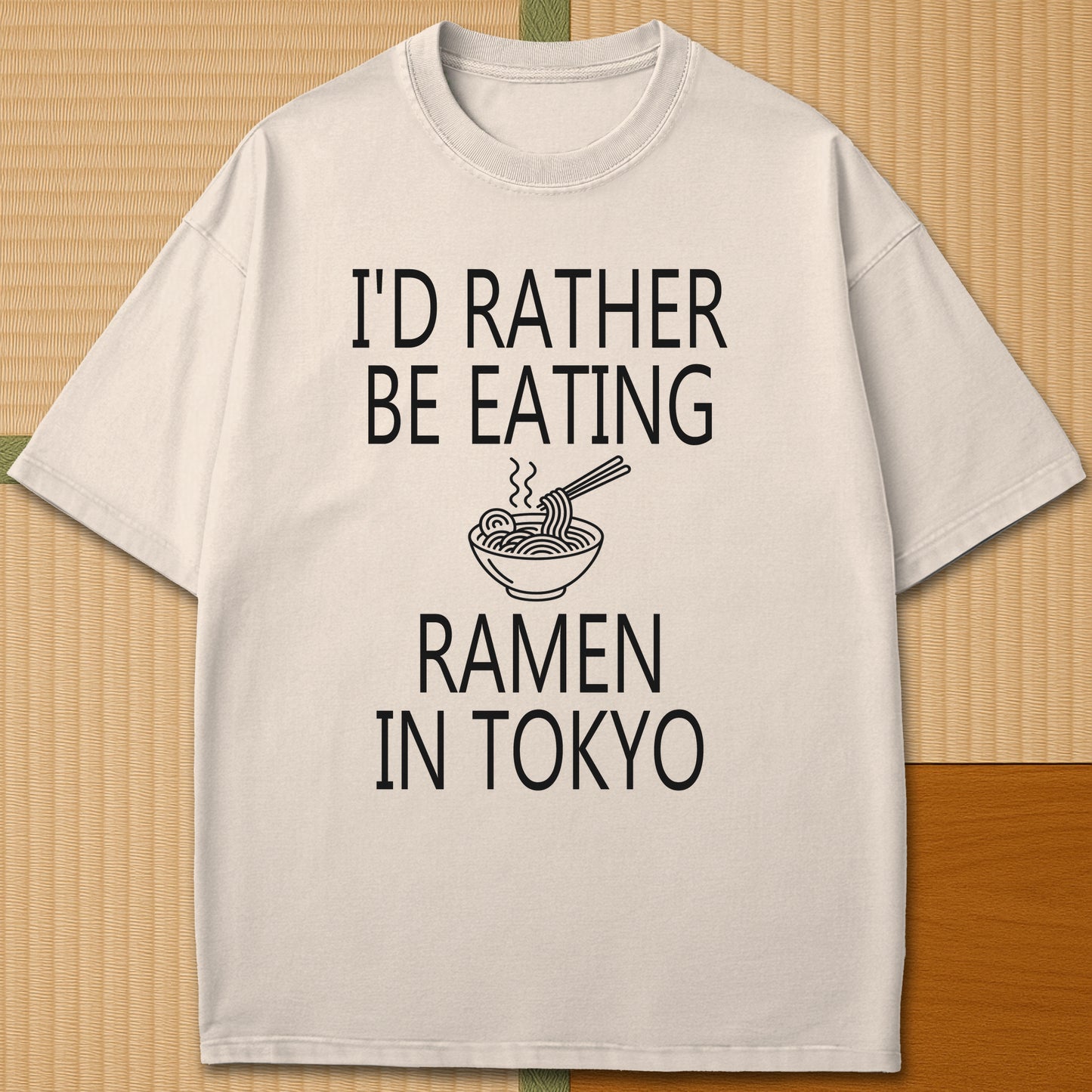 Japanese-inspired cotton Rather Be Eating Ramen T-Shirt in Ivory on Comfort Colors 1717, styled in a modern flatlay scene.