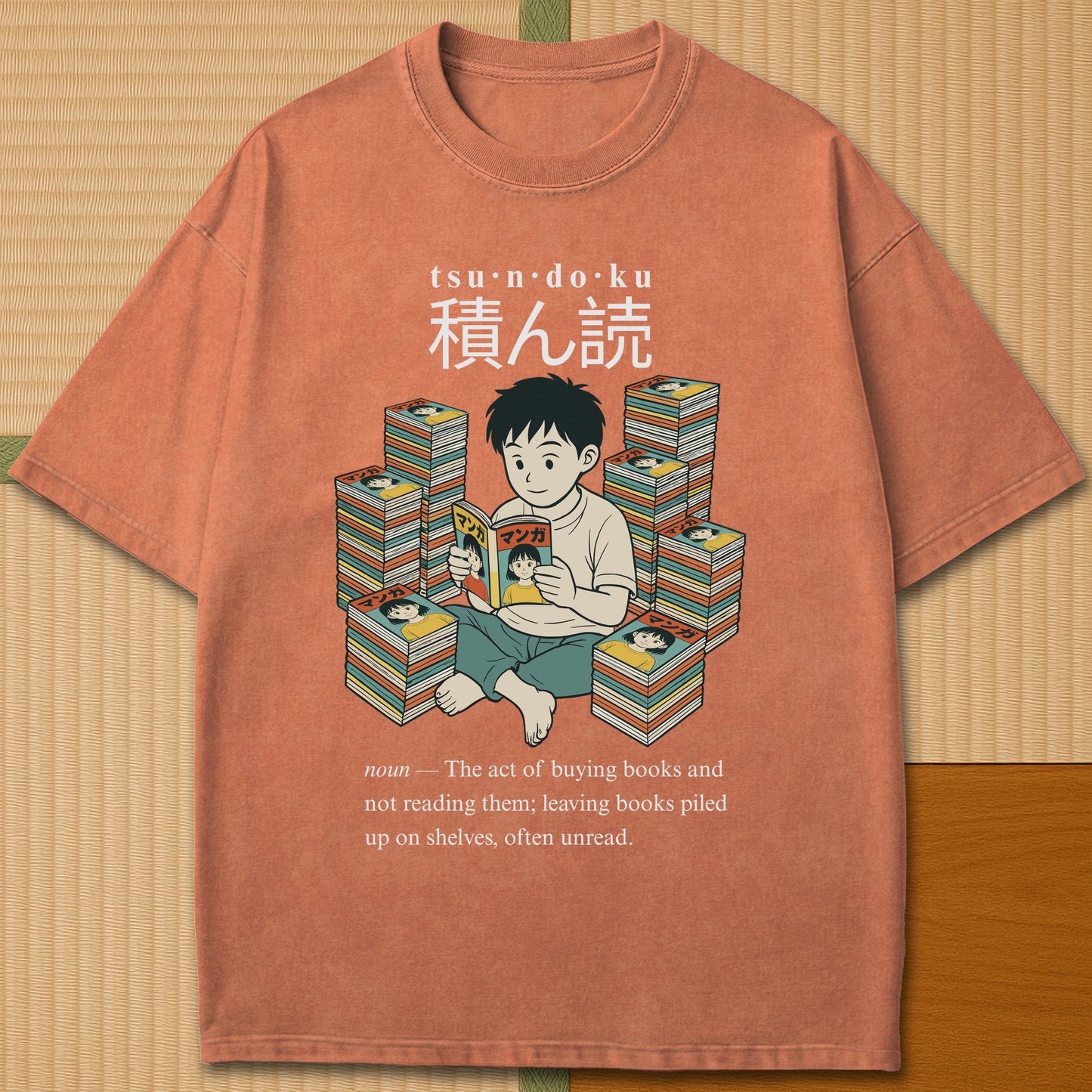 Japanese-inspired cotton Tsundoku Boy Manga Collector T-Shirt in Yam on Comfort Colors 1717, styled in a modern flatlay scene.