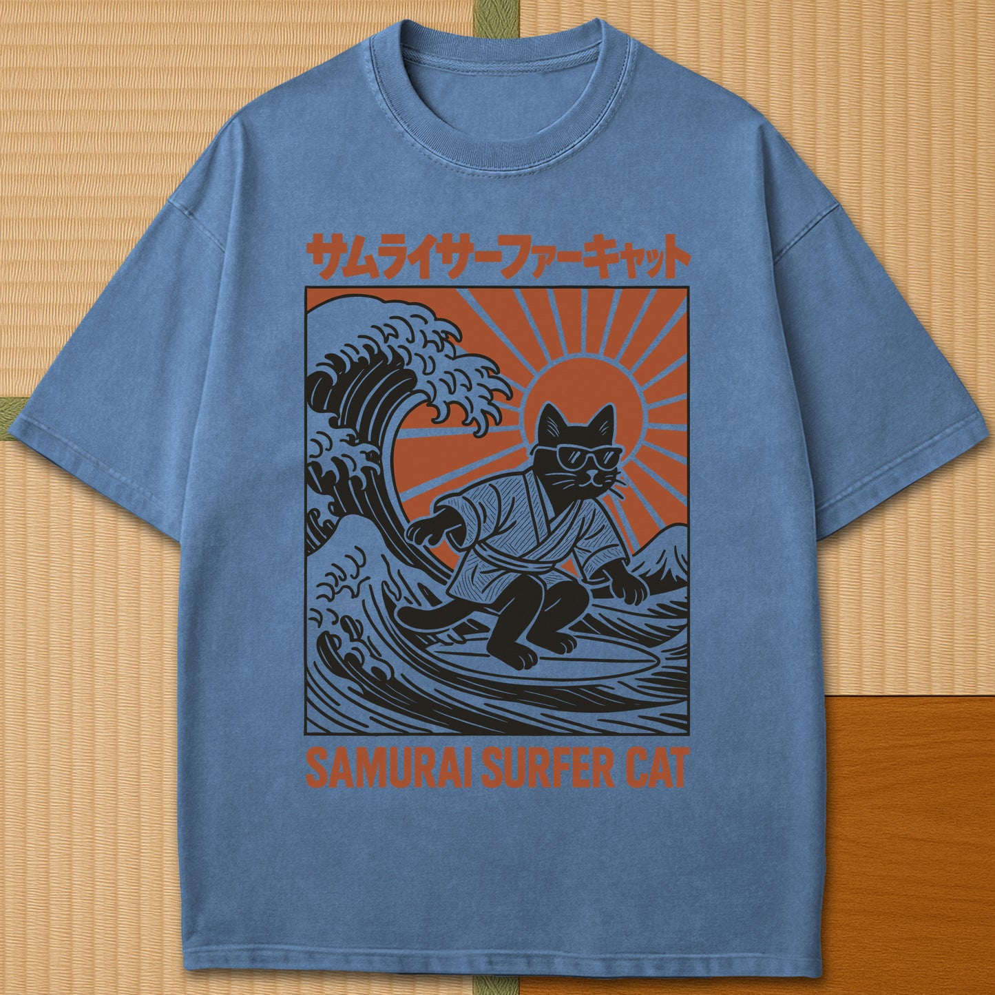 Japanese-inspired cotton Samurai Surfer Cat T-Shirt in Blue Jean on Comfort Colors 1717, styled in a modern flatlay scene.