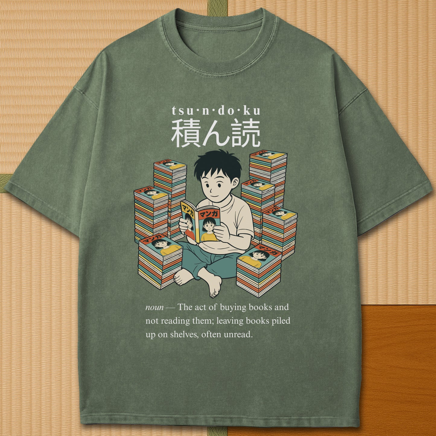 Japanese-inspired cotton Tsundoku Boy Manga Collector T-Shirt in Moss on Comfort Colors 1717, styled in a modern flatlay scene.