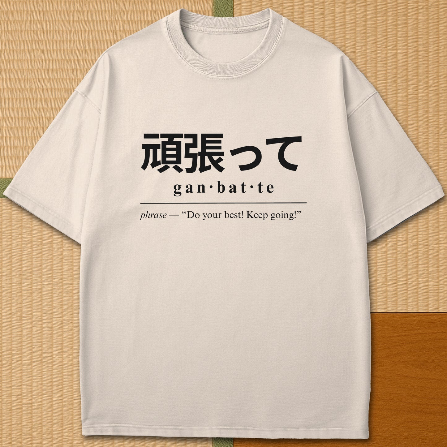 Japanese-inspired cotton Ganbatte Japanese Dictionary T-Shirt in Ivory on Comfort Colors 1717, styled in a modern flatlay scene.