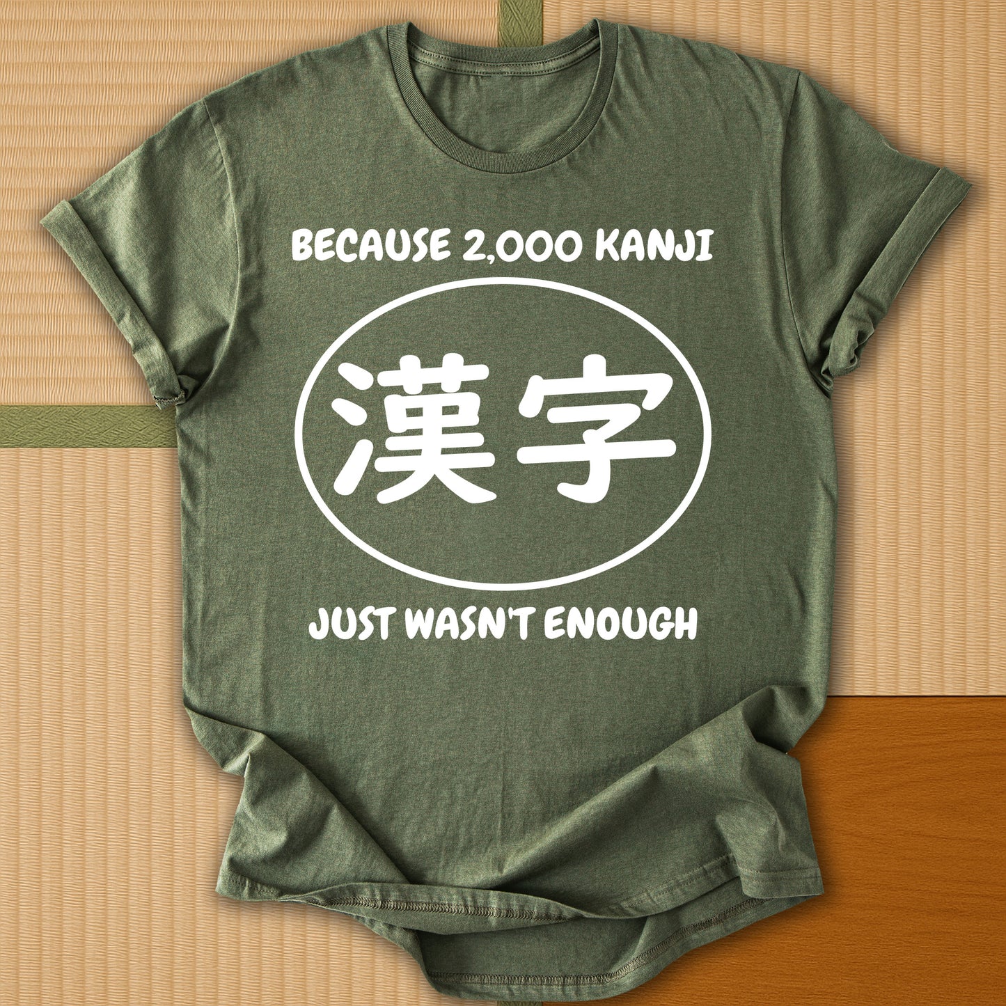 Japanese-inspired cotton Never Enough Kanji T-Shirt in Military Green on Gildan 64000, styled in a modern flatlay scene
