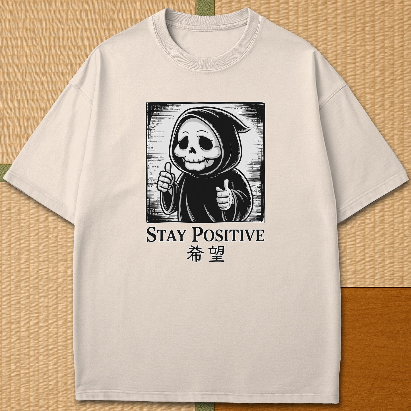 Japanese-inspired cotton Stay Positive Kawaii Grim Reaper T-Shirt in Ivory on Comfort Colors 1717, styled in a modern flatlay scene.
