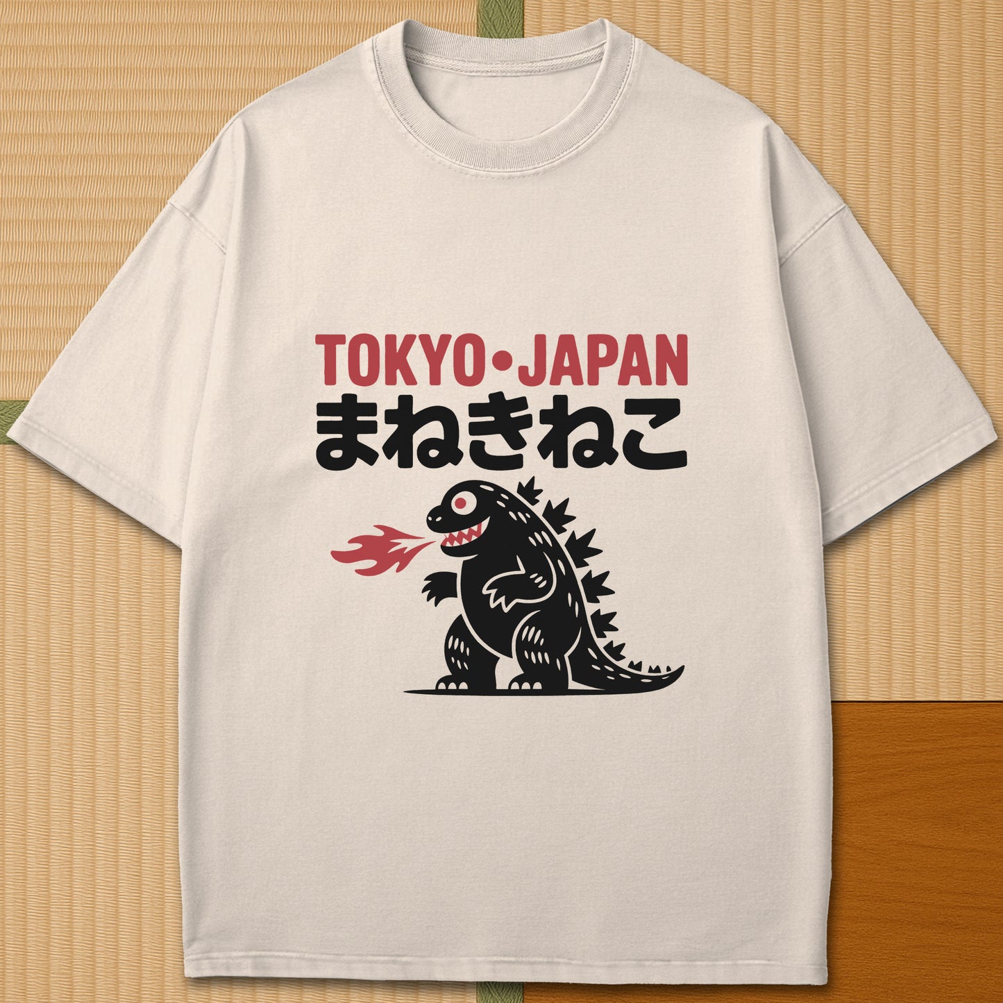 Japanese-inspired cotton Maneki Neko Monster T-Shirt in Ivory on Comfort Colors 1717, styled in a modern flatlay scene.