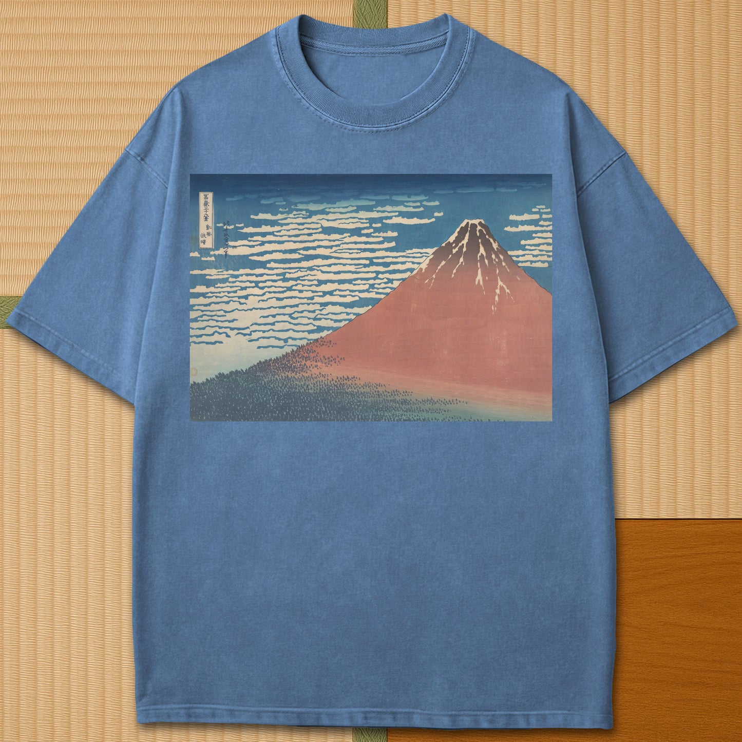 Japanese-inspired cotton Red Fuji By Hokusai T-Shirt in Blue Jean on Comfort Colors 1717, styled in a modern flatlay scene.