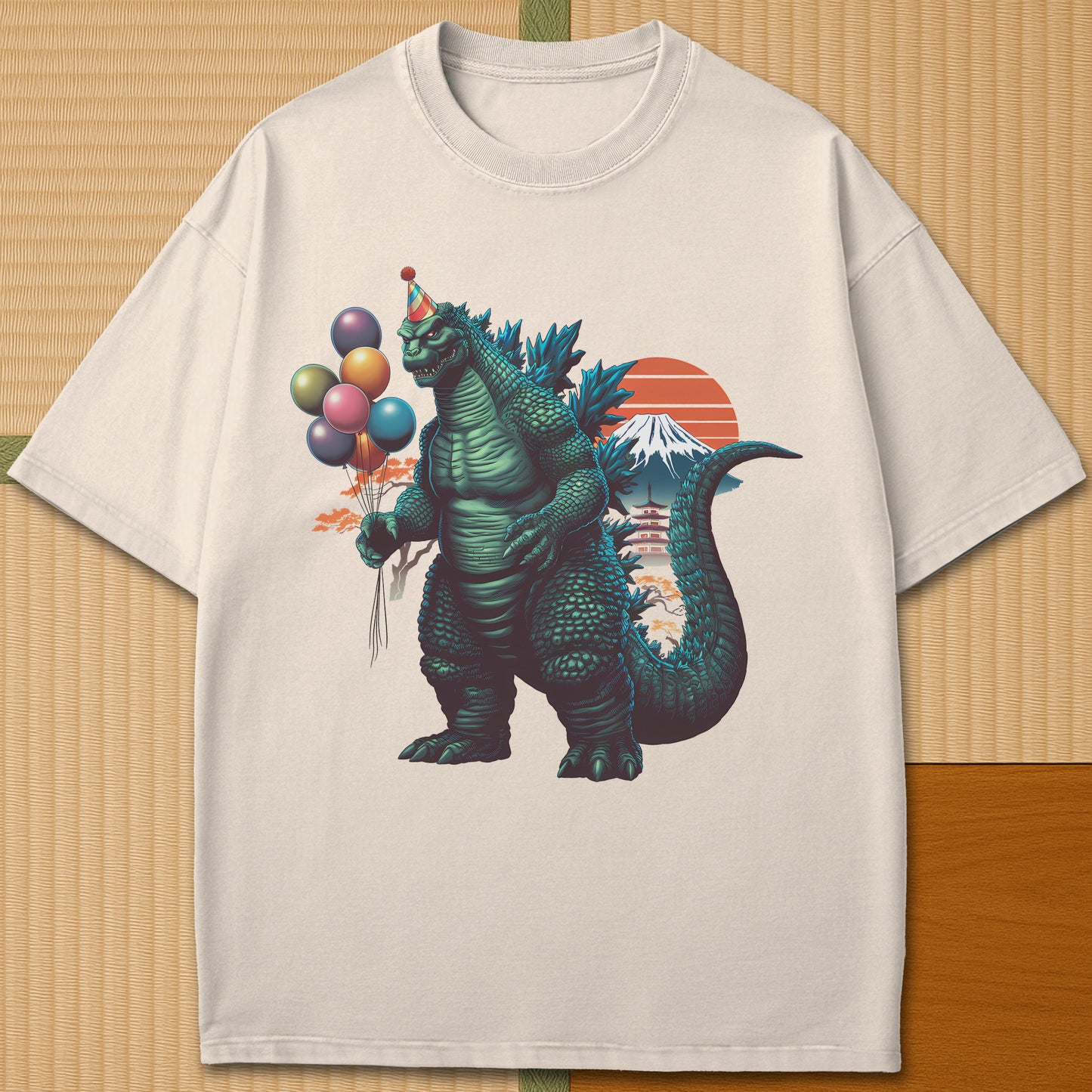 Japanese-inspired cotton Birthday Kaiju T-Shirt in Ivory on Comfort Colors 1717, styled in a modern flatlay scene.