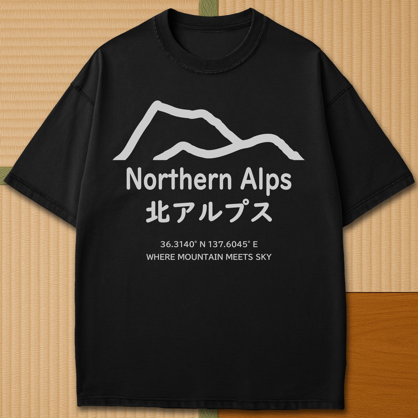 Japanese-inspired cotton Northern Alps Japan T-Shirt in Black on Comfort Colors 1717, styled in a modern flatlay scene.