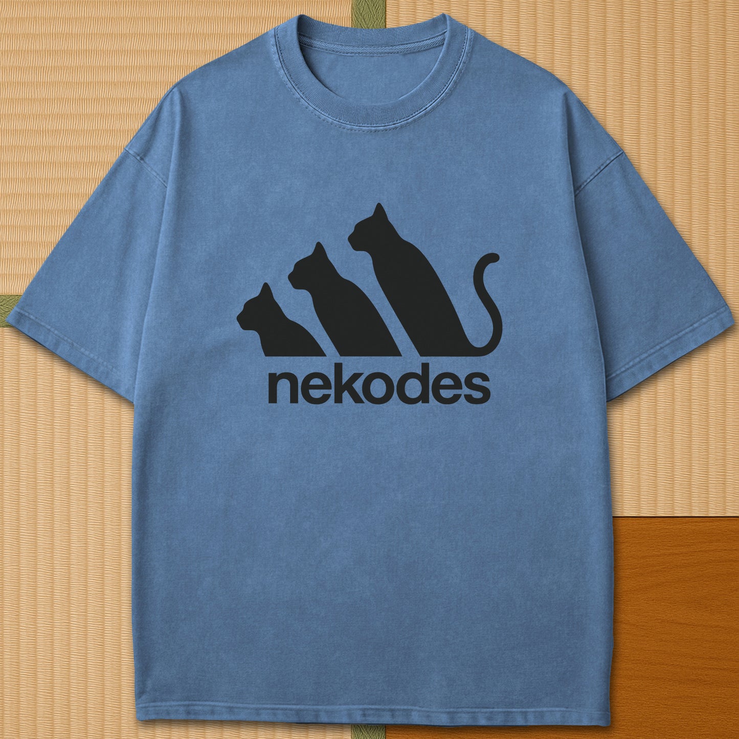 Japanese-inspired cotton Nekodes T-Shirt in Blue Jean on Comfort Colors 1717, styled in a modern flatlay scene.