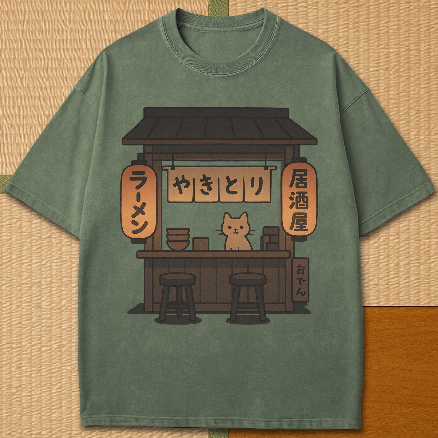 Japanese-inspired cotton Cozy Cat At Japanese Yatai T-Shirt in Moss on Comfort Colors 1717, styled in a modern flatlay scene.