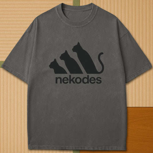 Japanese-inspired cotton Nekodes T-Shirt in Pepper on Comfort Colors 1717, styled in a modern flatlay scene.