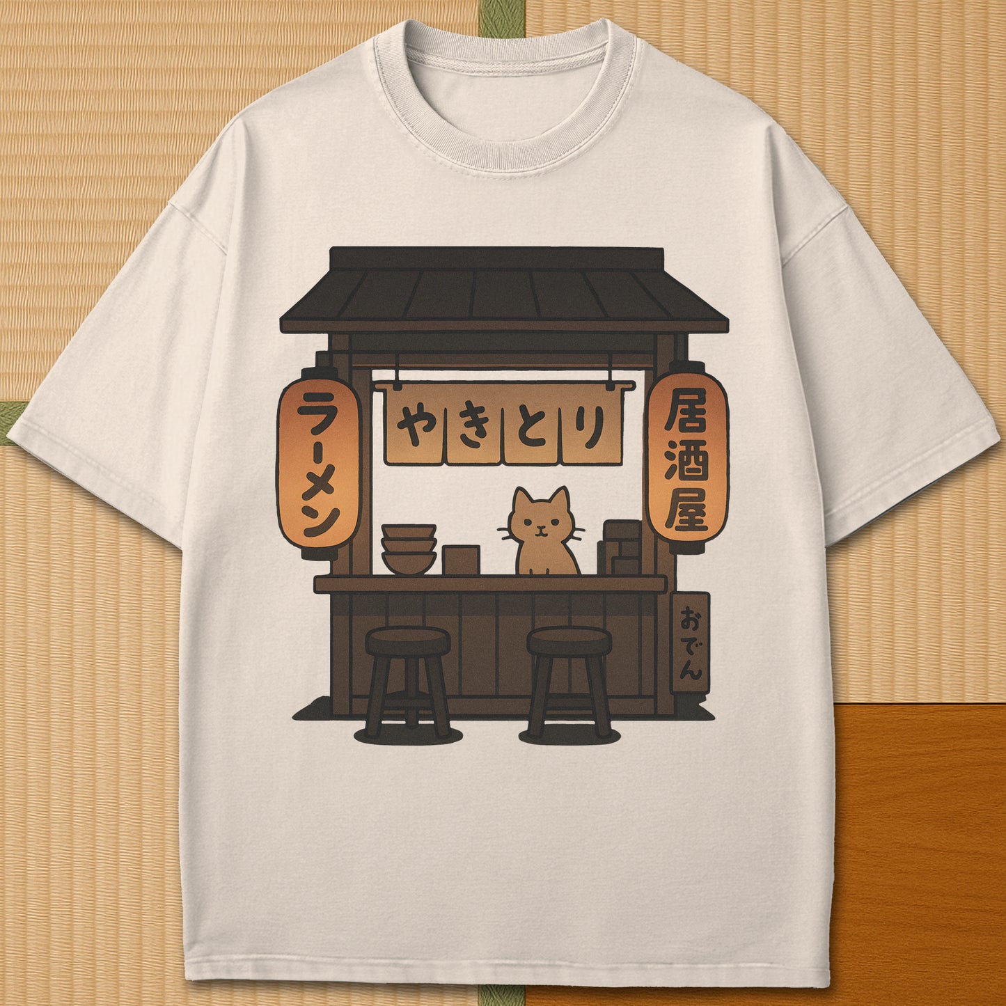 Japanese-inspired cotton Cozy Cat At Japanese Yatai T-Shirt in Ivory on Comfort Colors 1717, styled in a modern flatlay scene.