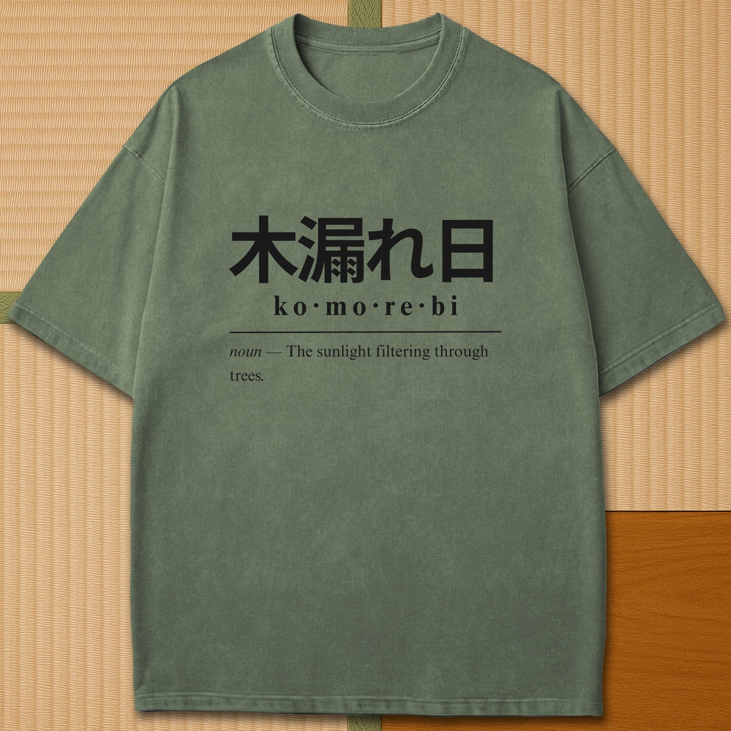 Japanese-inspired cotton Komorebi Japanese Dictionary T-Shirt in Moss on Comfort Colors 1717, styled in a modern flatlay scene.