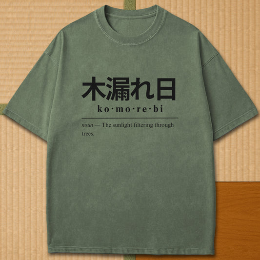 Japanese-inspired cotton Komorebi Japanese Dictionary T-Shirt in Moss on Comfort Colors 1717, styled in a modern flatlay scene.