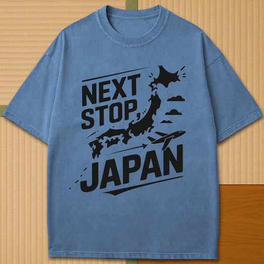 Japanese-inspired cotton Next Stop Japan T-Shirt in Blue Jean on Comfort Colors 1717, styled in a modern flatlay scene.