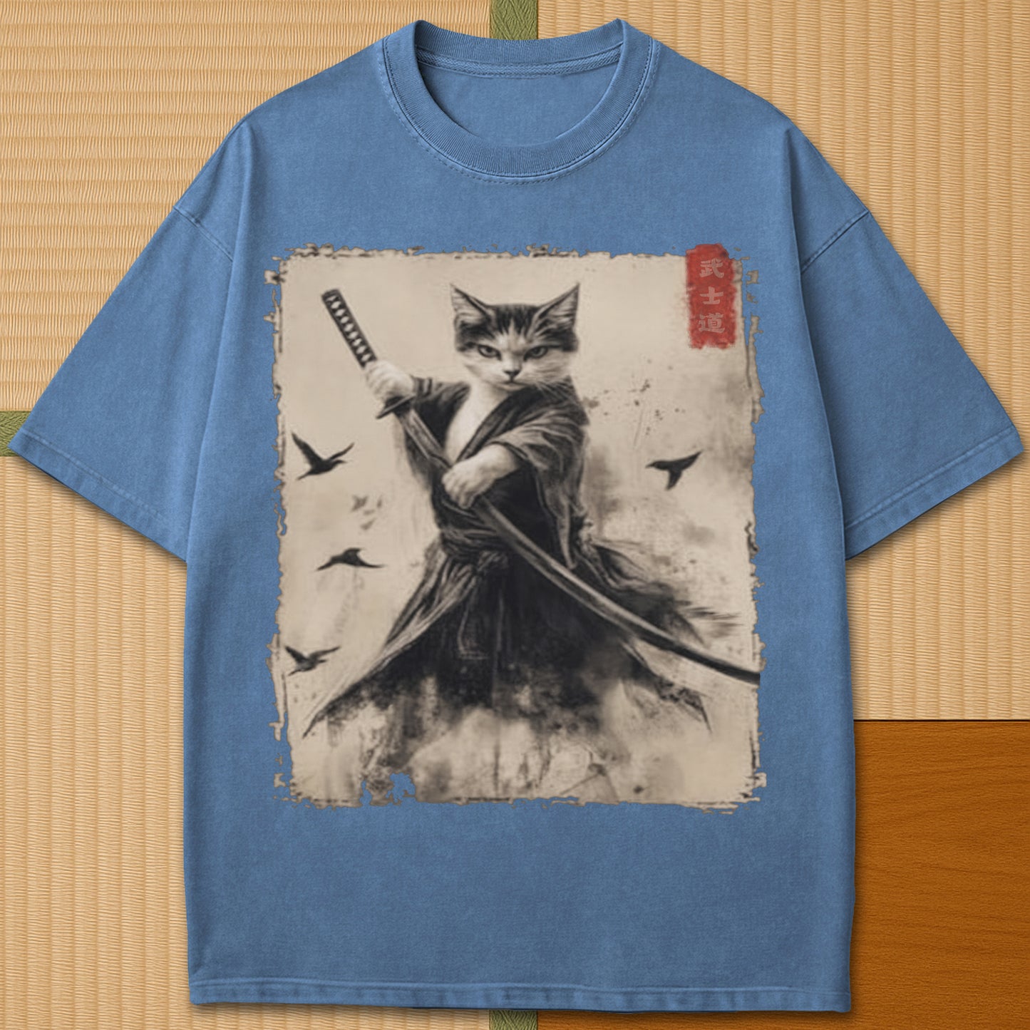 Japanese-inspired cotton Cat Samurai T-Shirt in Blue Jean on Comfort Colors 1717, styled in a modern flatlay scene.