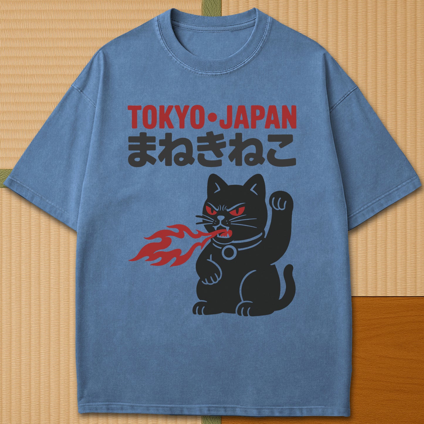 Japanese-inspired cotton Maneki Neko Monster T-Shirt in Blue Jean on Comfort Colors 1717, styled in a modern flatlay scene.