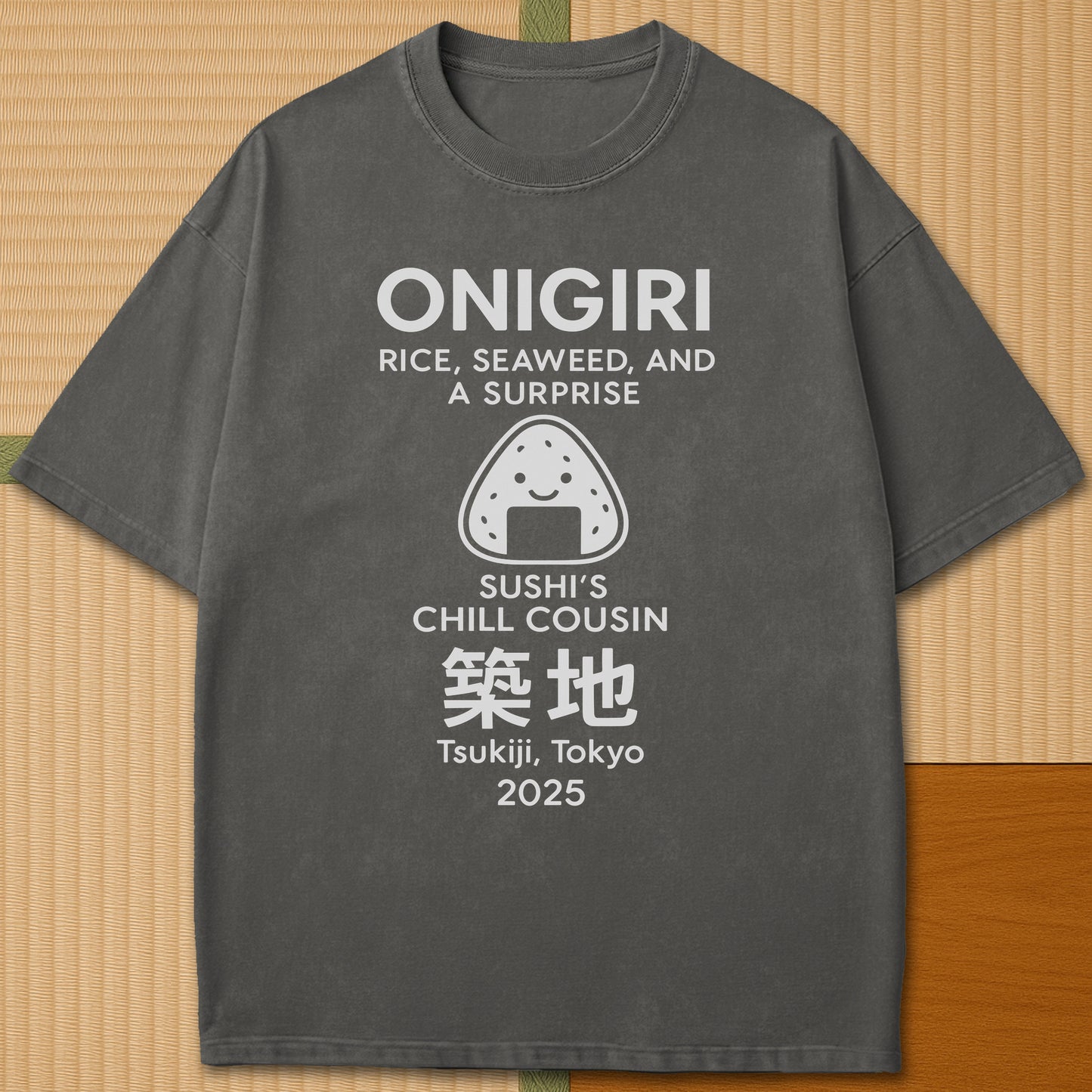Japanese-inspired cotton Onigiri Chill Cousin Of Sushi T-Shirt in Pepper on Comfort Colors 1717, styled in a modern flatlay scene.