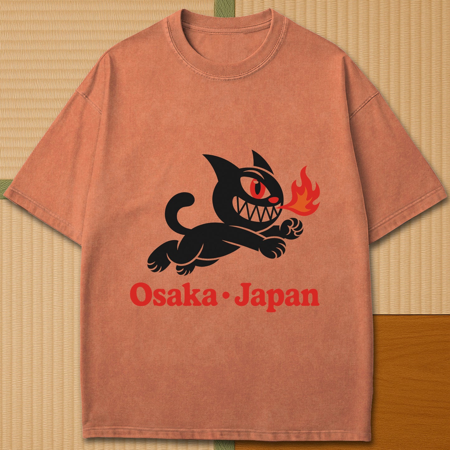 Japanese-inspired cotton Mischievous Cat Osaka T-Shirt in Yam on Comfort Colors 1717, styled in a modern flatlay scene.
