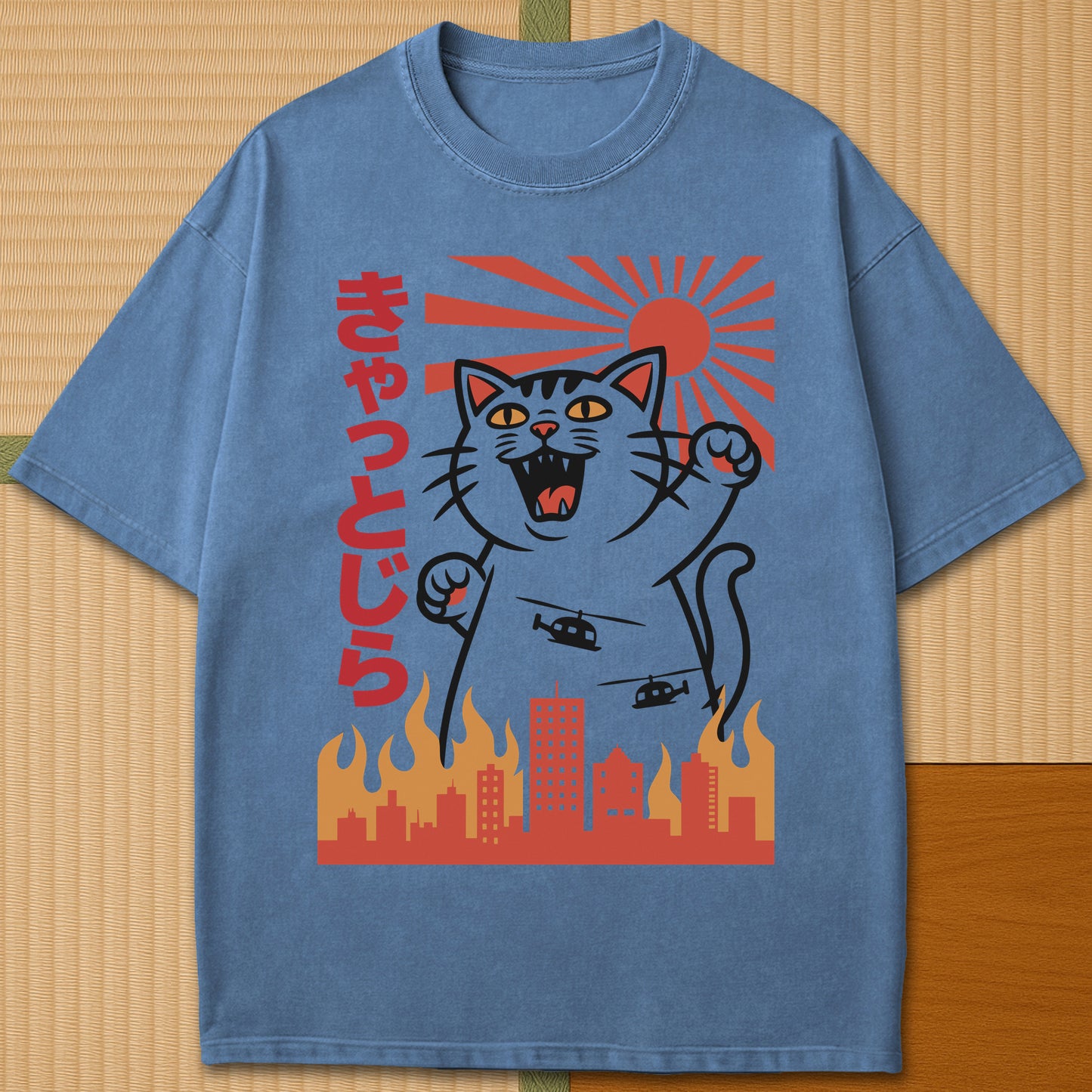 Japanese-inspired cotton Catzilla Rising Sun T-Shirt in Blue Jean on Comfort Colors 1717, styled in a modern flatlay scene.