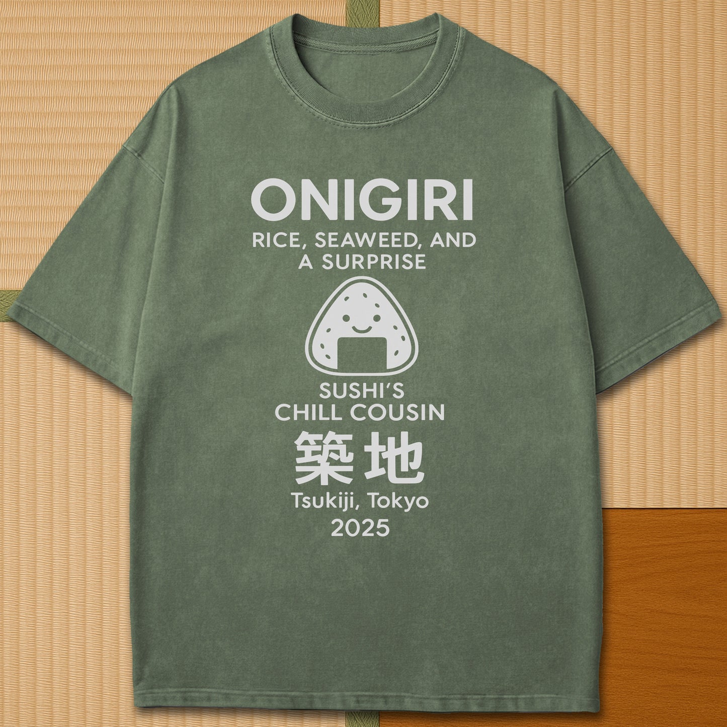 Japanese-inspired cotton Onigiri Chill Cousin Of Sushi T-Shirt in Moss on Comfort Colors 1717, styled in a modern flatlay scene.