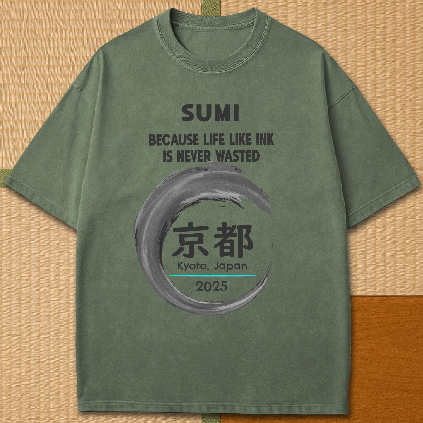 Japanese-inspired cotton Sumi Life Kyoto T-Shirt in Moss on Comfort Colors 1717, styled in a modern flatlay scene.