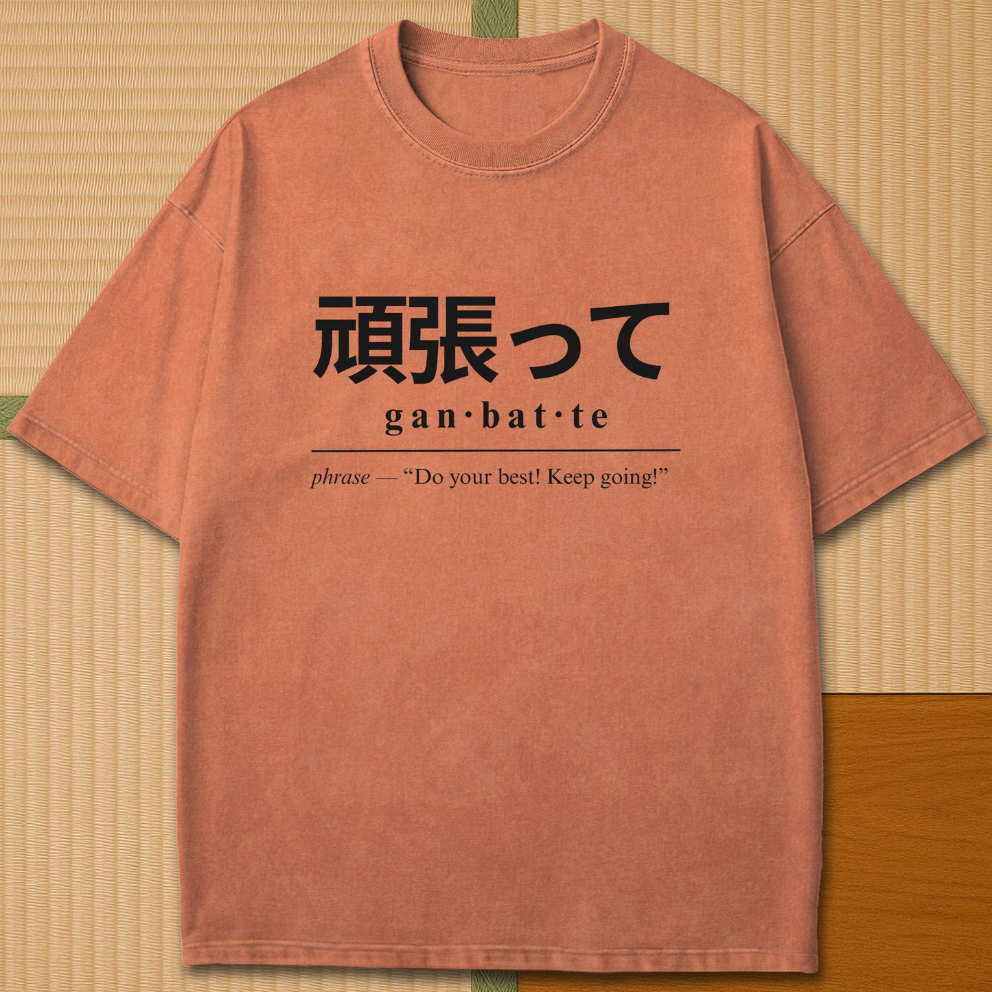 Japanese-inspired cotton Ganbatte Japanese Dictionary T-Shirt in Yam on Comfort Colors 1717, styled in a modern flatlay scene.