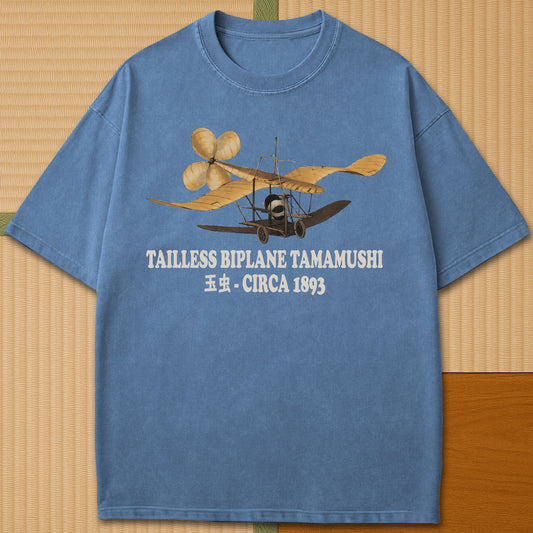 Japanese-inspired cotton Tailless Biplane T-Shirt in Blue Jean on Comfort Colors 1717, styled in a modern flatlay scene.