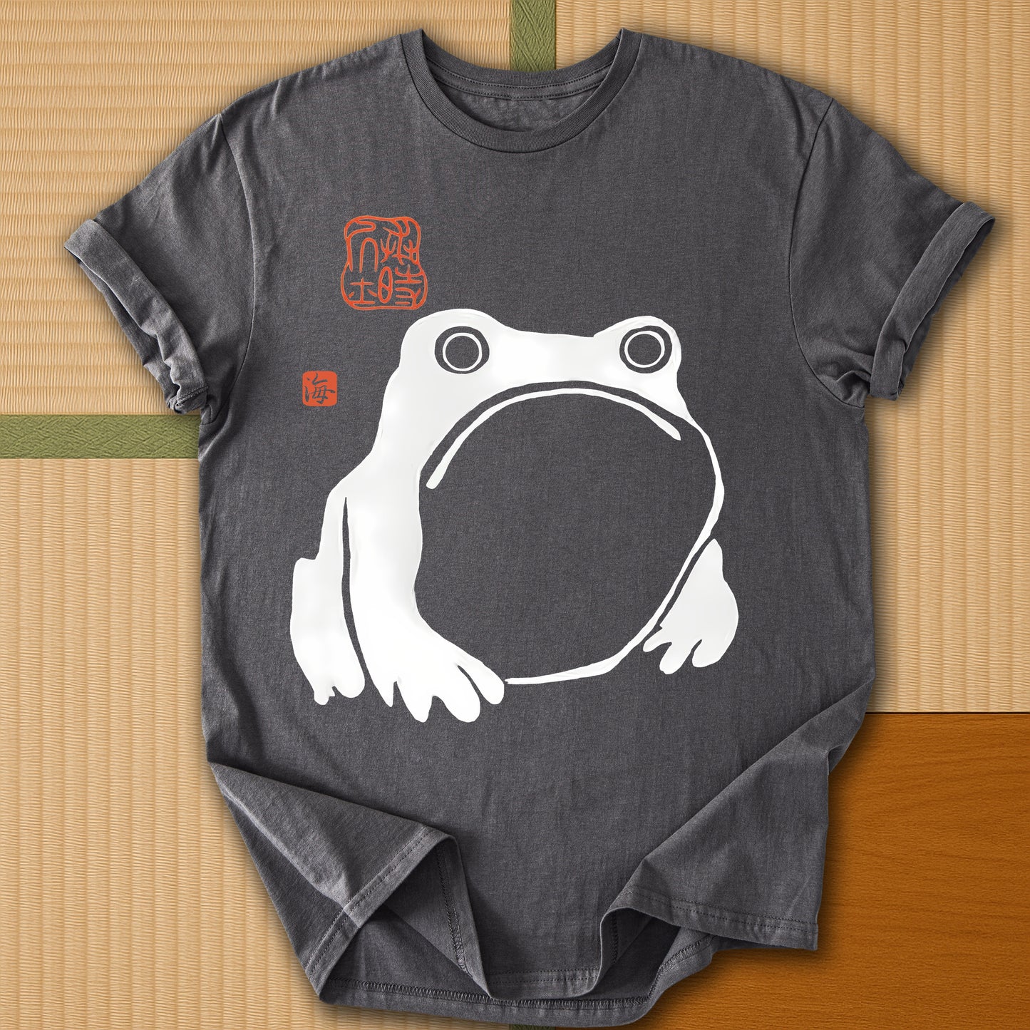 Japanese-inspired cotton Frowning Frog Print T-Shirt in Charcoal on Gildan 64000, styled in a modern flatlay scene