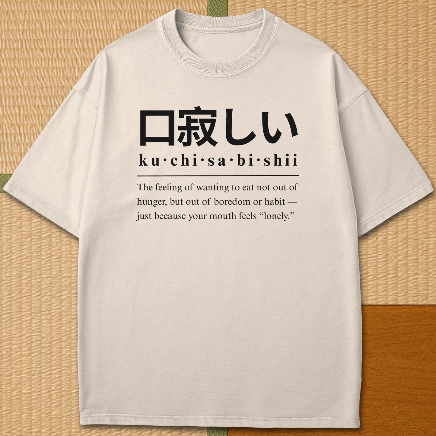 Japanese-inspired cotton Japanese Kuchisabishii Definition T-Shirt in Ivory on Comfort Colors 1717, styled in a modern flatlay scene.